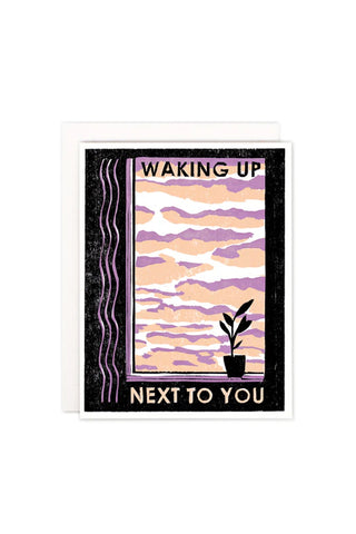 Card with a purple and pink sky design with a plant and text 'Waking Up Next To You' on a white background