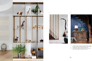 Decorative bookshelf with animal figurines, indoor plants, and a staircase with colorful decor.