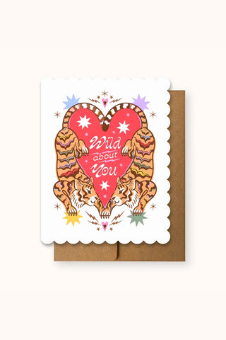 Greeting card with two symmetrical tigers. Their tails are in the shape of a heart with text that reads 'Wild about you'