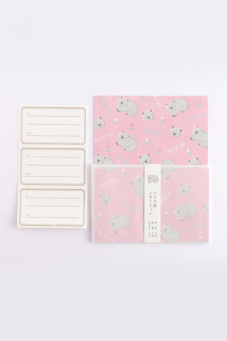 Letter set with wombat illustrations on pink paper next to letter seals