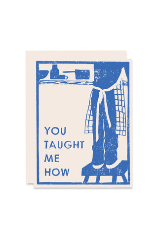 Card with blue and white graphic design of child on a stool with text 'You Taught me How'