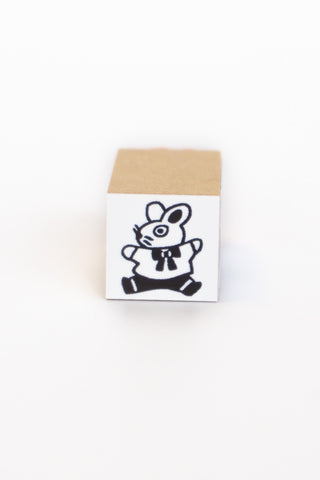 Stamp of an illustrated rabbit wearing and outfit and jumping