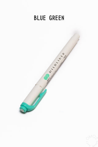 White highlighter with green cap on a white background