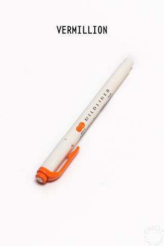White pen with orange cap and clip on a white background.
