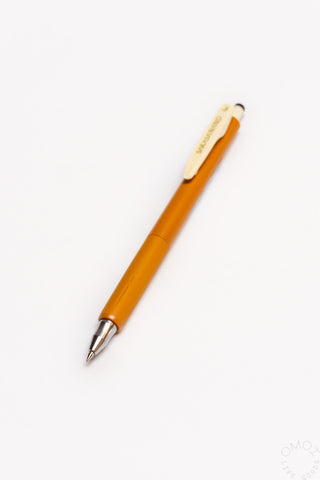 Orange pen with a gold clip on a white background