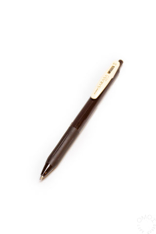 Brown pen with a white clip on a white background