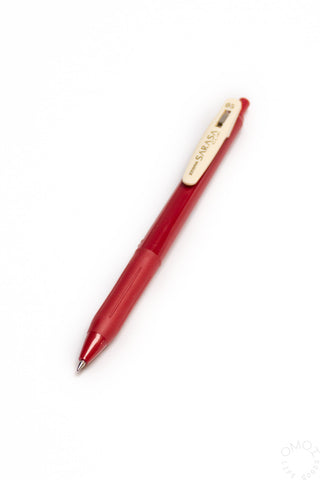 Red pen with a white clip on a white background
