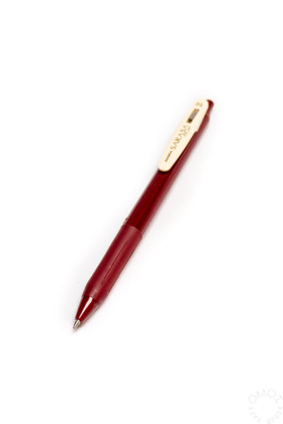 Red pen with a white clip on a white background