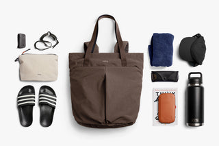 Tote bag with various items to show capacity such as water bottle, book, hat, sandals, pouch