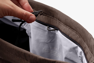 Close-up of a hand holding a clasp inside of tote bag
