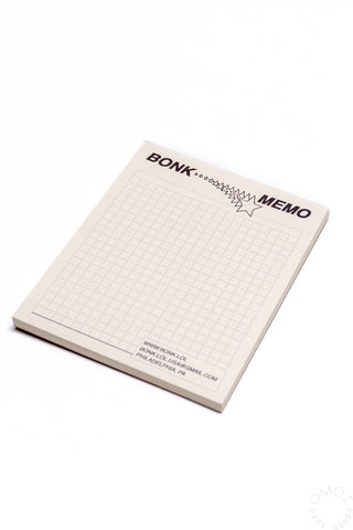 Black Memo pad with grid pattern and 'BONK' branding on a white background