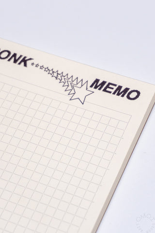 Memo pad with grid paper and 'MEMO' text on a white background