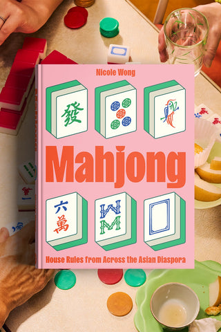 Book titled 'Mahjong: House Rules from Across the Asian Diaspora' by Nicole Wong on a table with mahjong tiles.