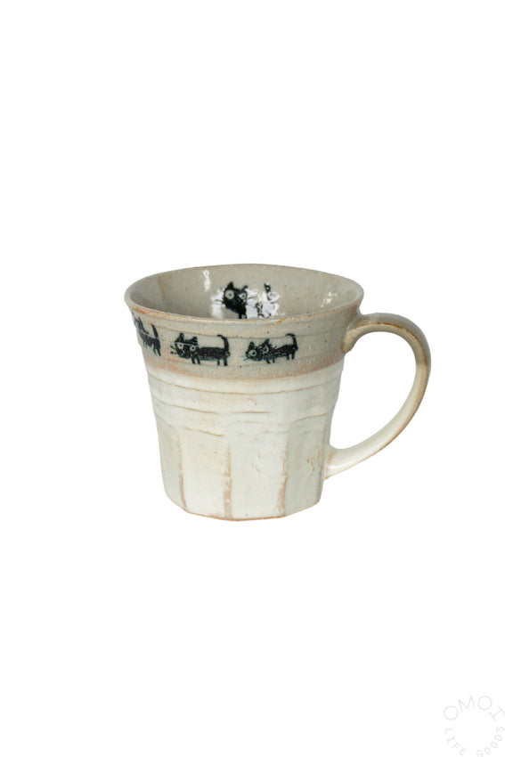 Cat-themed ceramic mug, cream body with black cat silhouettes and gray interior