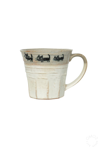 Front view of beige ceramic ug with cat parade design on a white background