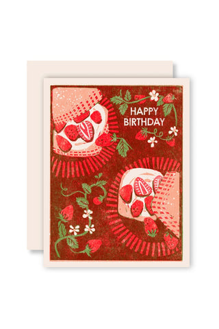 Birthday card with strawberry-themed design on a red background