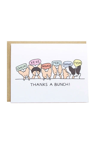 Card with cartoon dogs saying thank you in multiple languages, on a white background.