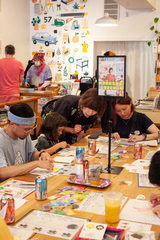 Naoshi helping a table full of people at a workshop