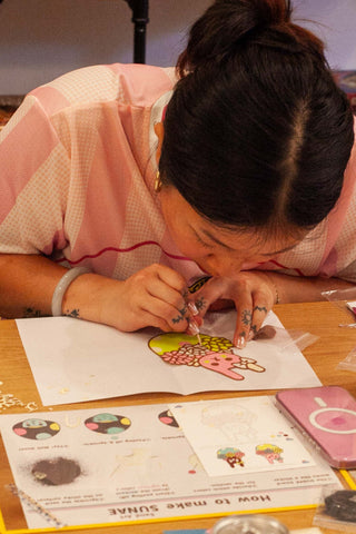 a person working on sand art