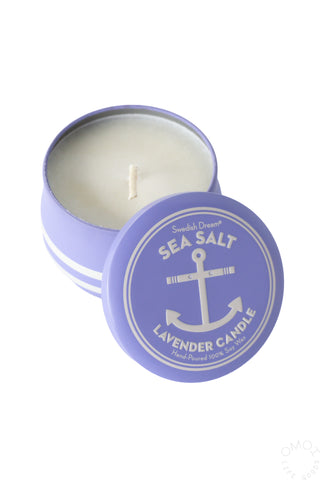 Tin lavender sea salt candle with lid in front on a white background
