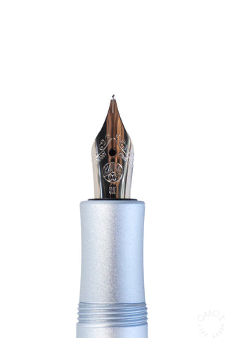 close up of a aluminum light blue fountain pen nib on a white background