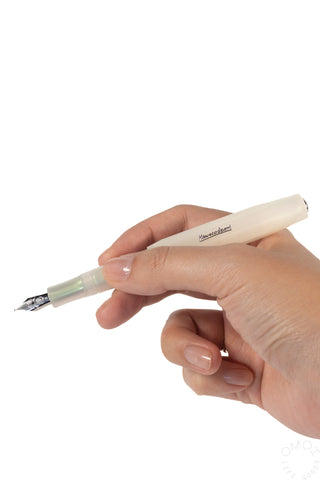 hand holding a light green kaweco fountain pen on a white background