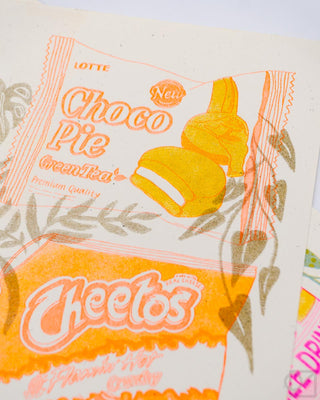 Close-up of an illustration of Choco Pie and Cheetos packaging with decorative elements.