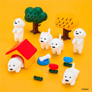 Set of small white animal figurines with colorful accessories on a yellow background