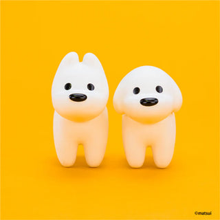 Two white dog-shaped figures on a yellow background