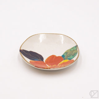 Small decorative plate with colorful flower design on a white background