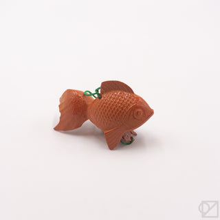Orange goldfish wind chime on a white background