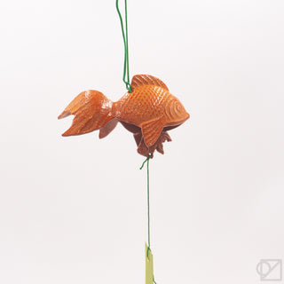 Decorative goldfish wind chime hanging on a string against a white background