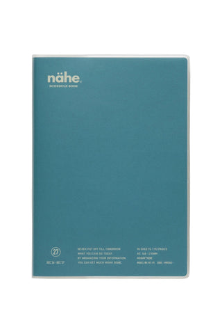 A teal blue notebook featuring the name 'nähe' printed in white near the top left, shown against a plain white background.