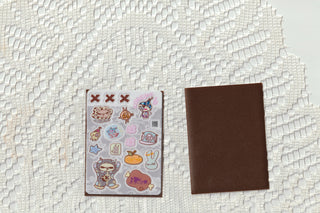 Love Letter opaque clear sticker sheet and brown card sleeve side by side on a white lace background