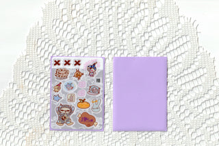 Love letter sticker sheet and purple card sleeve side by side on a white lace background