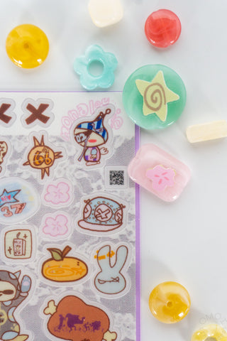 Close up of Love Letter sticker sheet with colorful beads on a white background