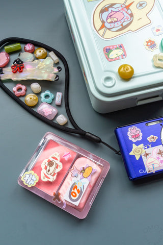 Pink case and blue toolbox decorated with stickers on a blue background