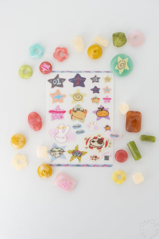 Filler Arc sticker sheet surrounded by colorful beads on a white background