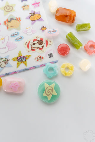 Close up of Filler Arc sticker sheet on a white background with colorful beads