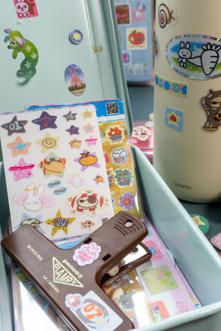 Nonalouie sticker sheets on a toolbox with a clampy