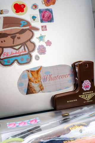 Close up of laptop decorated with stickers and brown penco clampy