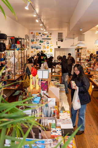 People shopping in a store with various products and decorations.