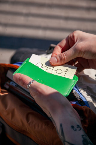 Person holding a green cardholder