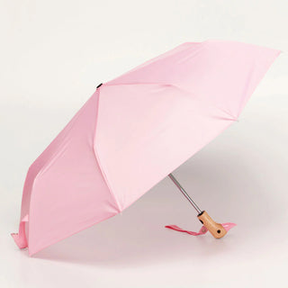 Pink umbrella with a wooden handle on a light gray background