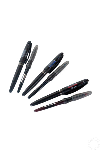 Assorted ink markers with pointed tips, including black, blue, and red.