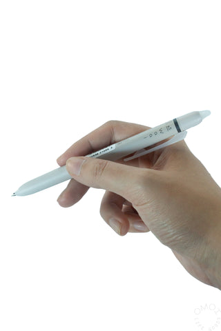 Hand holding a white erasable gel pen with fine tip
