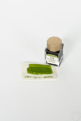 Sailor ink bottle with green ink swatch on a white background