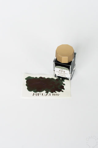 Sailor ink bottle with dark green ink swatch on a white background