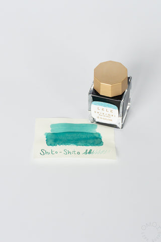 Sailor ink bottle with teal swatch on a white background