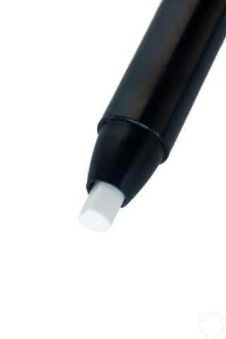 Close-up of white eraser refill tip at end of black barrel